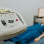 Medical examination setting with patient lying on bed, focus on healthcare device.
