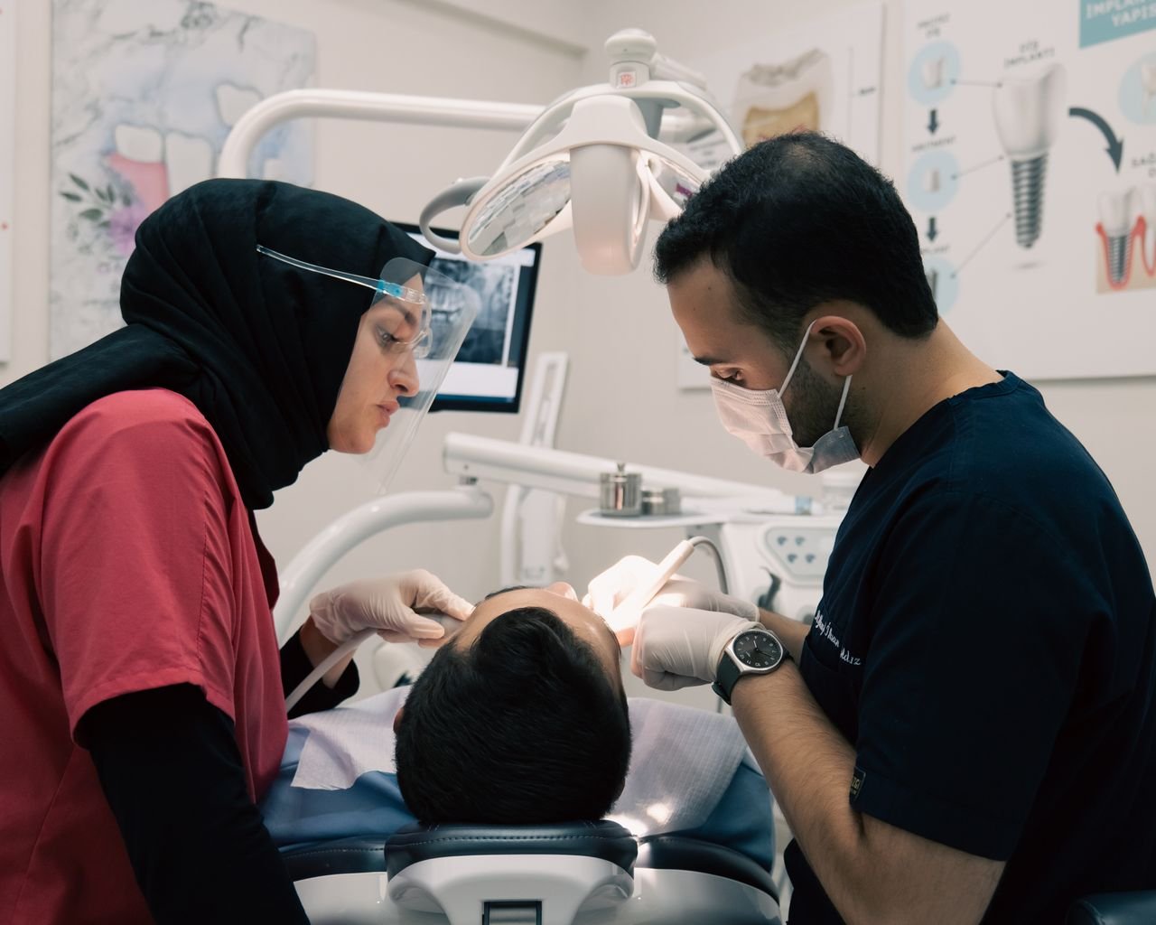 pexels photo 18524125 18524125 Dentist and assistant providing dental care to a patient with advanced equipment in a modern clinic.