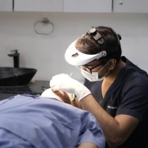 Home A dermatologist performing a procedure in a clinical setting in Delhi, India.